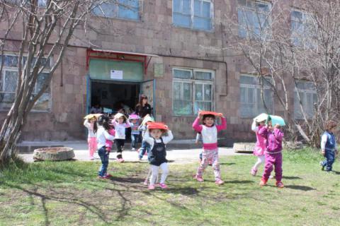 Kindergarten kids evacuating from the building at the earthquake evacuation drill